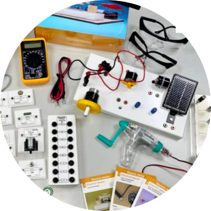 Physics kit contents: multimeter, circuit boards, solar panel, hand-crank generator, safety goggles and lesson cards